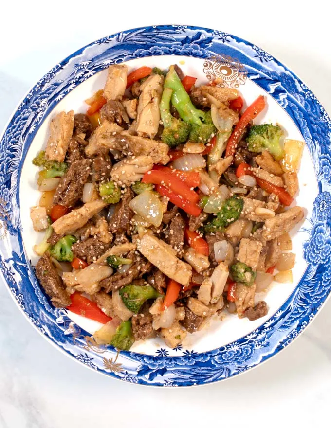 Chicken and Steak Stir Fry served on a plate.