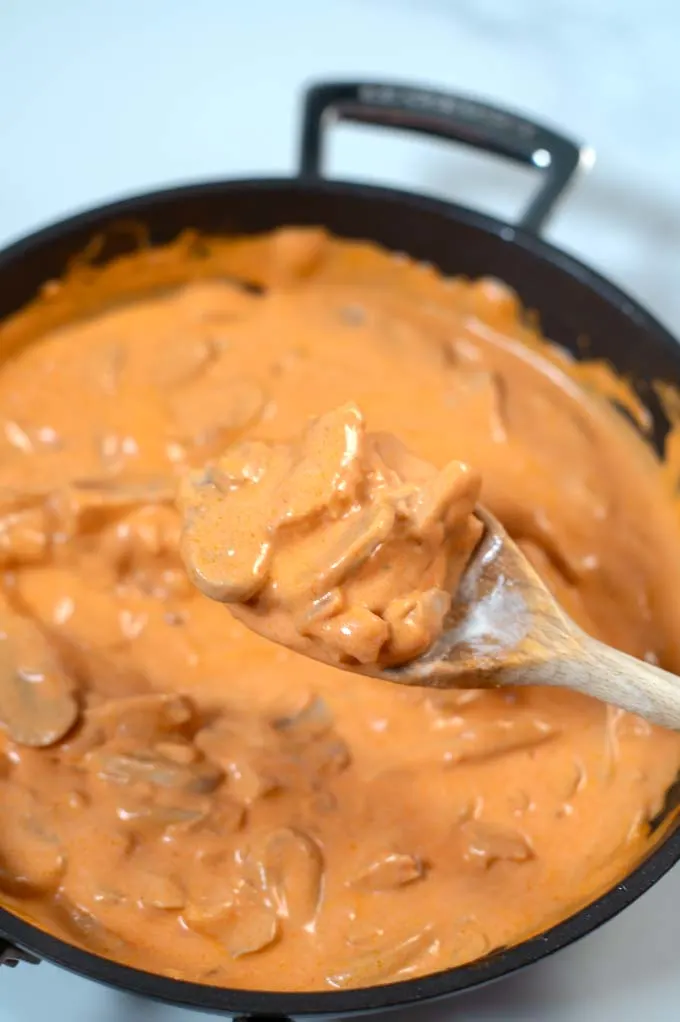 View of a wooden spoon with Brazilian Stroganoff.