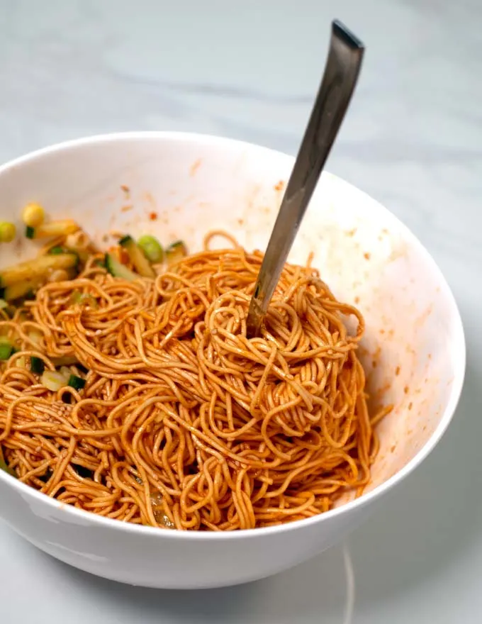 A fork in a serving of Korean Cold Noodles.