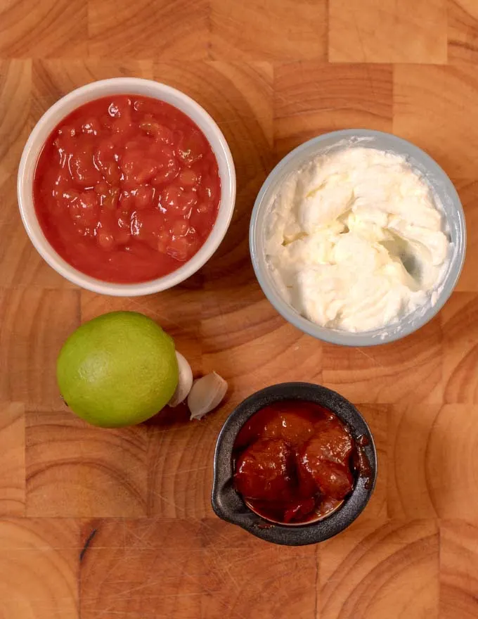 Ingredients needed to make Salsa Crema on a board.