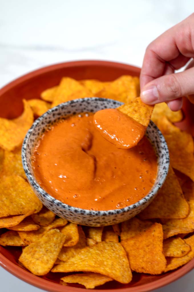 Dipping a tortilla chip into Salsa Crema.