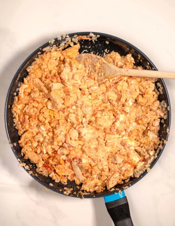 Top view of a pan with the chicken-cauliflower rice mixture.