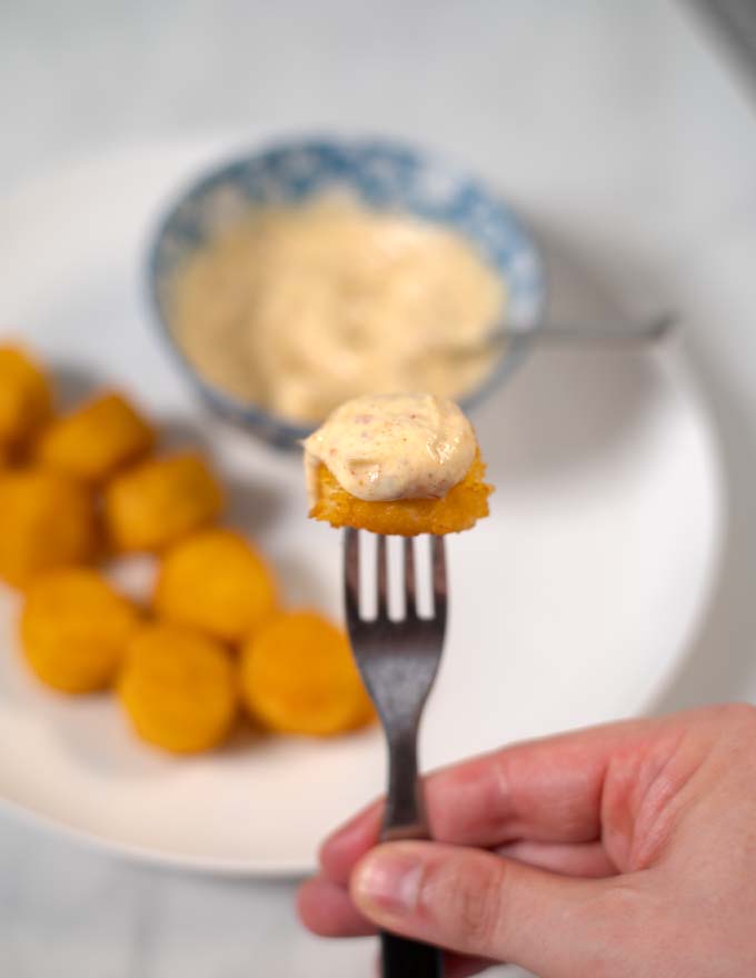 Closeup on a single chicken pop with spicy mayo.