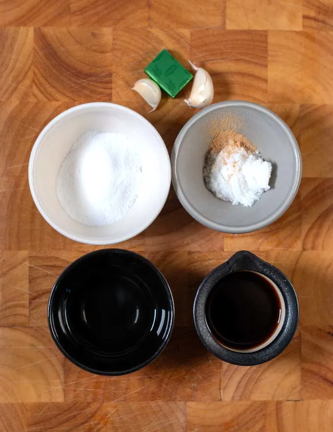 Ingredients needed to make Thai Brown Sauce on a cutting board.