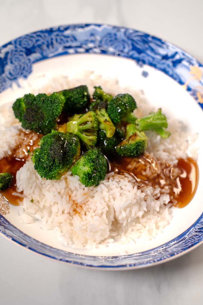 Closeup on a serving of white rice with broccoli covered in Thai Brown Sauce.