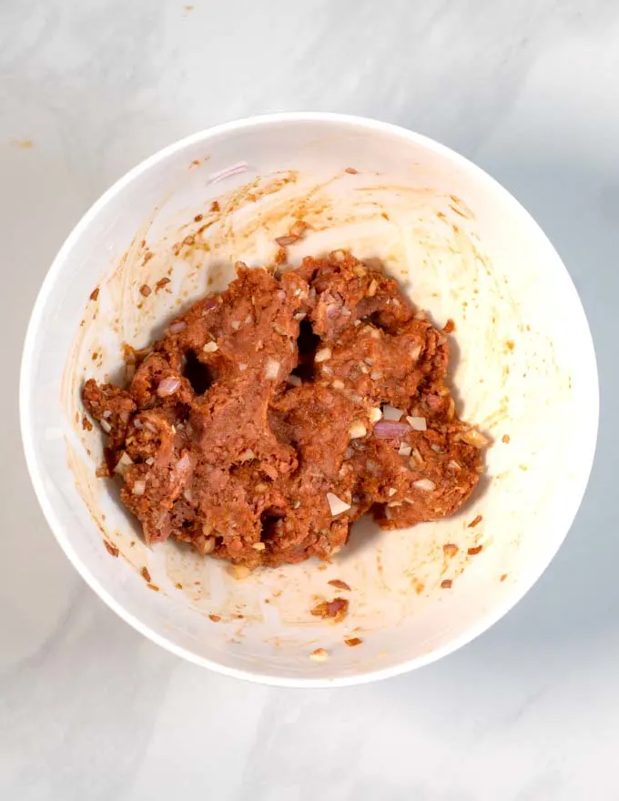 View of a mixing bowl with the mixture for making Vietnamese Meatballs.