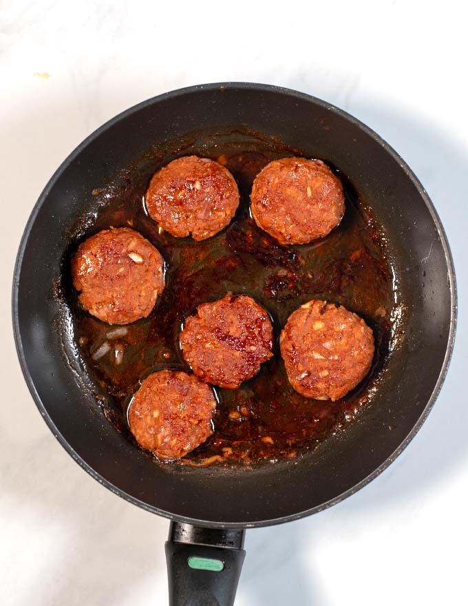 Top view of six Vietnamese Meatballs done in a pan.