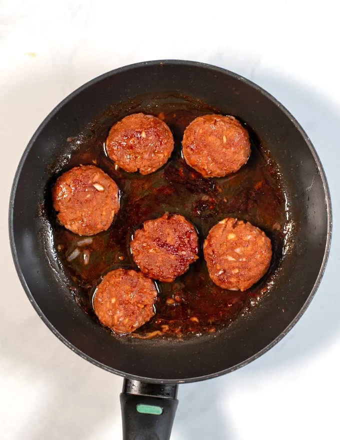 Top view of six Vietnamese Meatballs done in a pan.