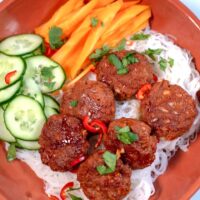 A serving of Vietnamese Meatballs with cucumbers, carrots, and noodles.