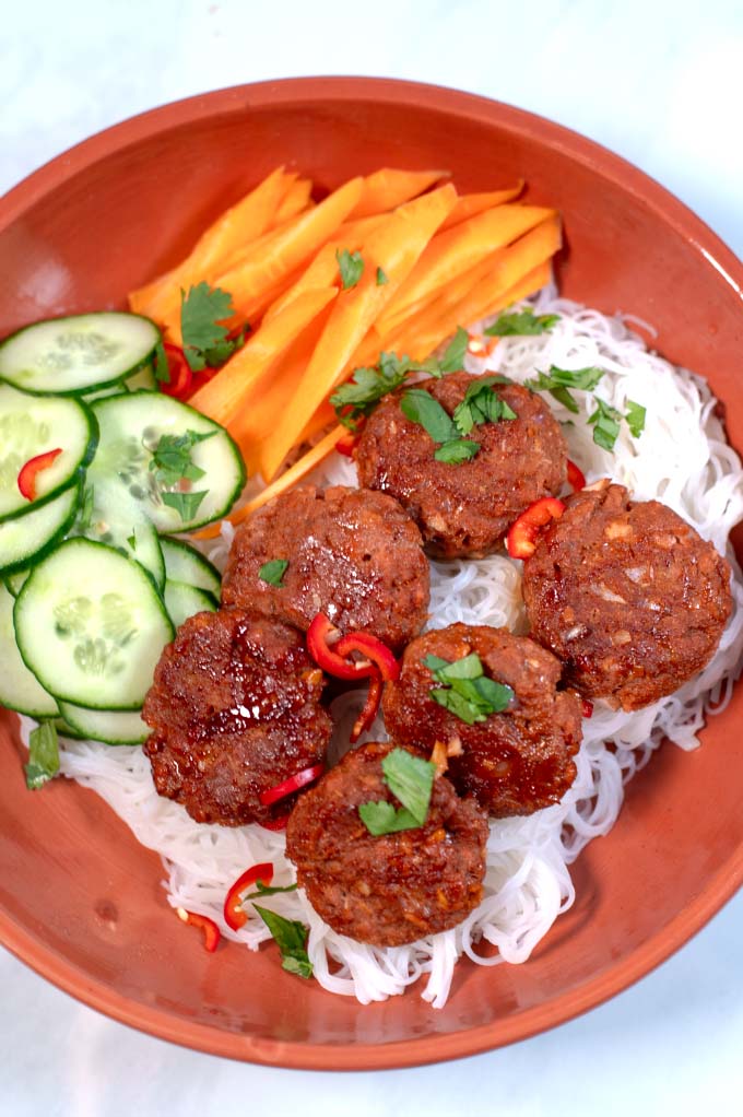 A serving of Vietnamese Meatballs with cucumbers, carrots, and noodles.