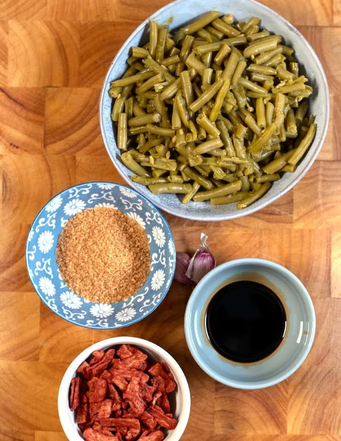 Ingredients needed to make Canned French Style Green Beans on a board.