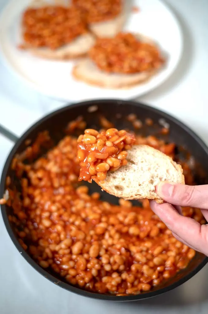 English Baked Beans scooped up with a piece of bread.