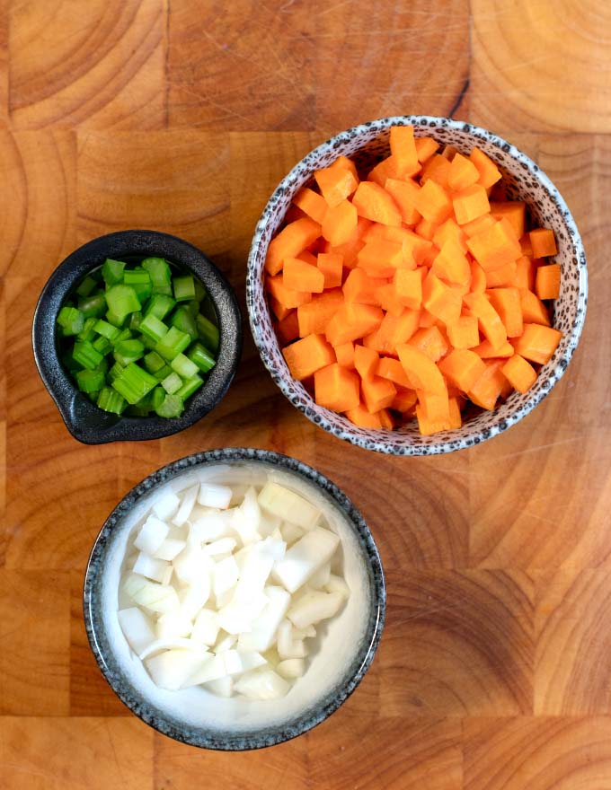 Ingredients for Italian Sofrito on a board.