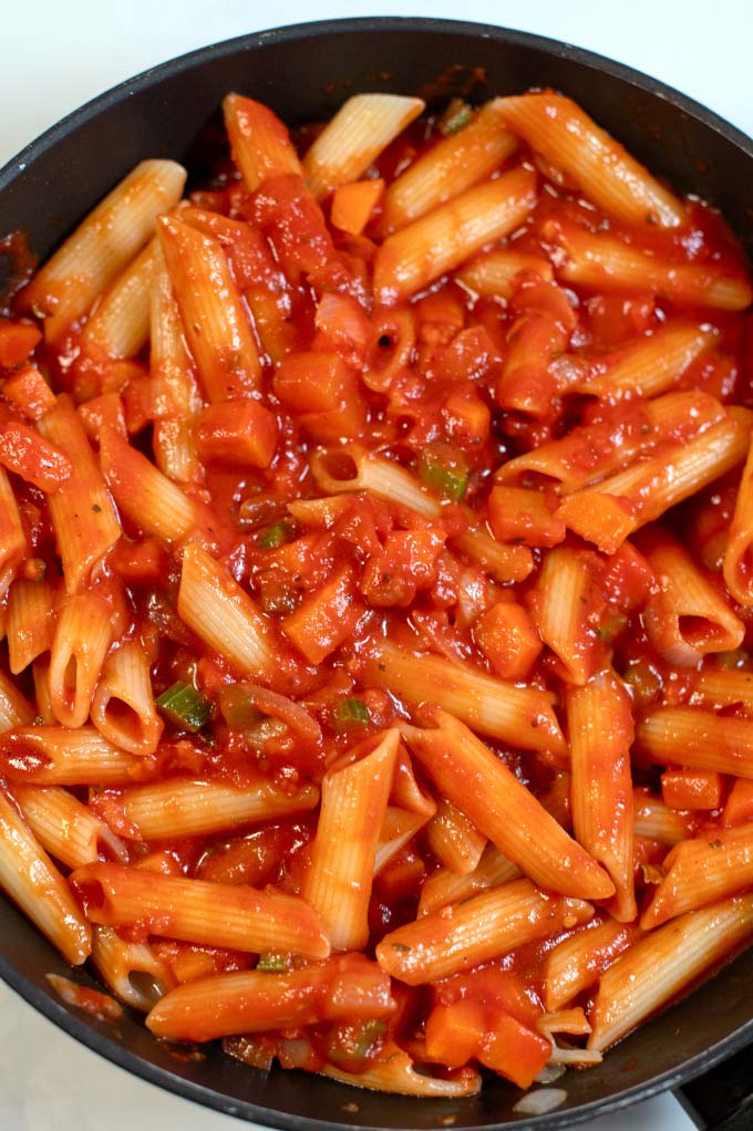 Closeup of pasta in sauce.