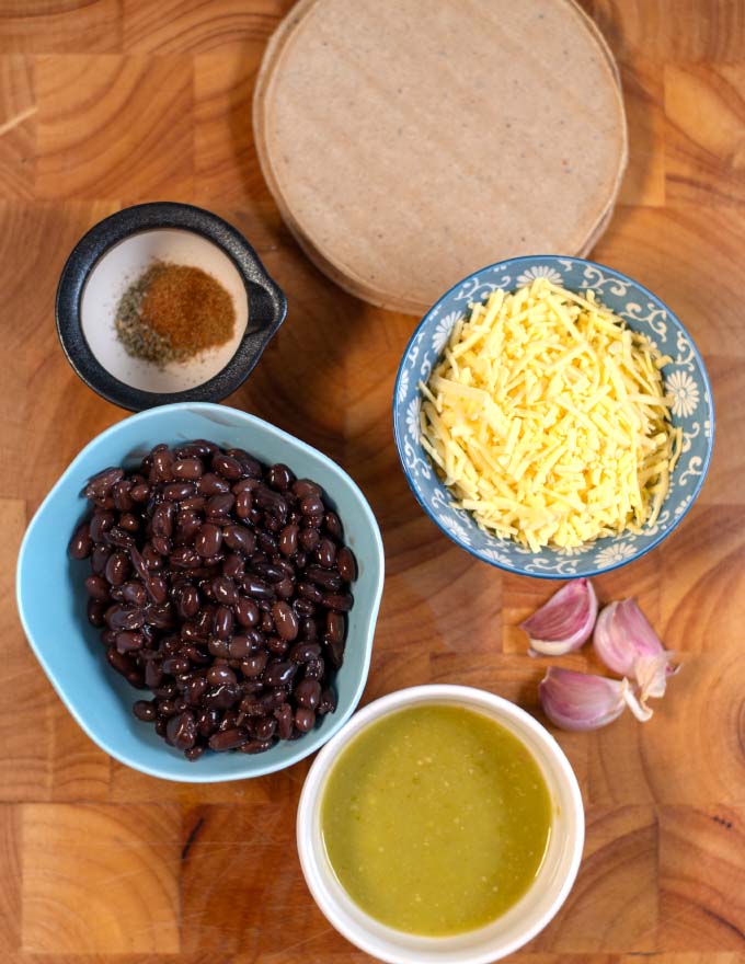 Ingredients needed to make Mexican Chalupas collected on a board.