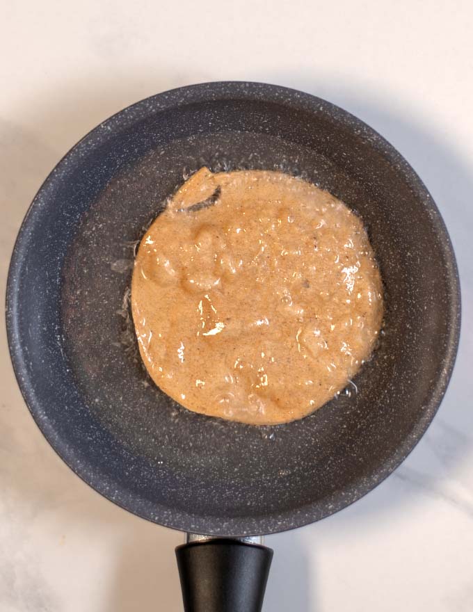 Tortillas are fried in a small pan.