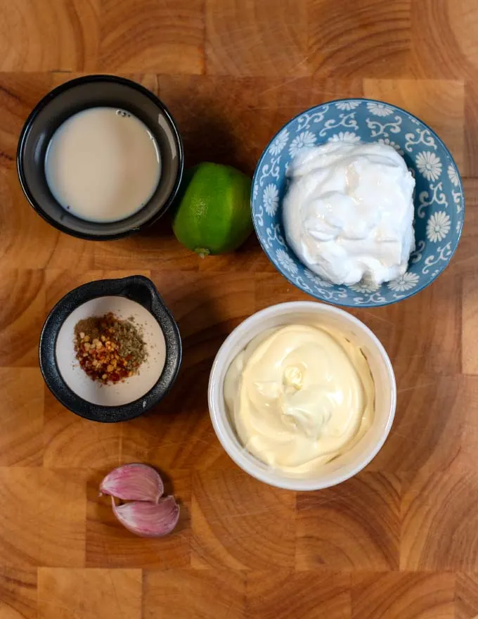 Ingredients needed to make Mexican White Sauce on a board.