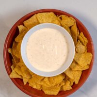 Serving of Mexican White Sauce with chips.