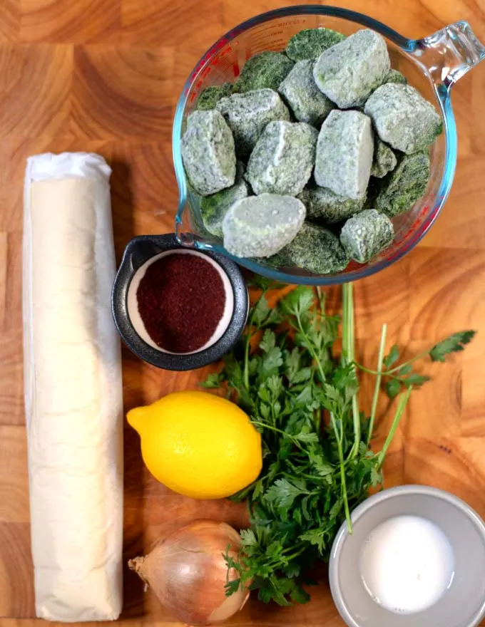 Ingredients needed to make Spinach Fatayer on a board.