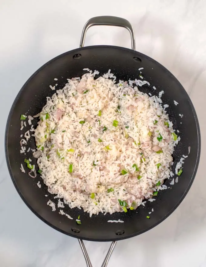 Top view of rice and vegetables in a wok.