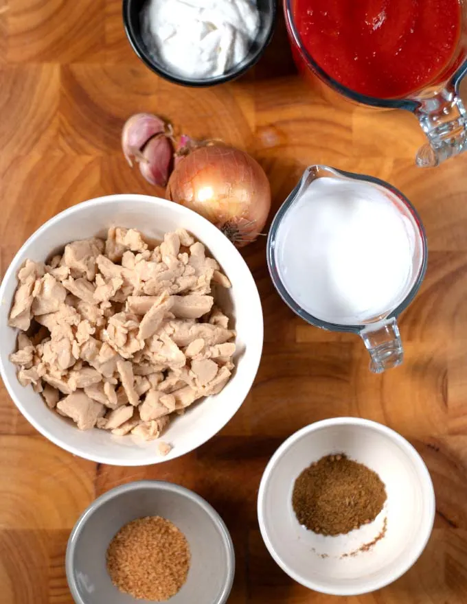 Ingredients needed for making vegan Chicken Masala on a board.