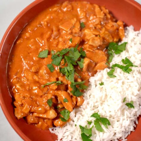 Closeup of a serving of Chicken Masala with rice.