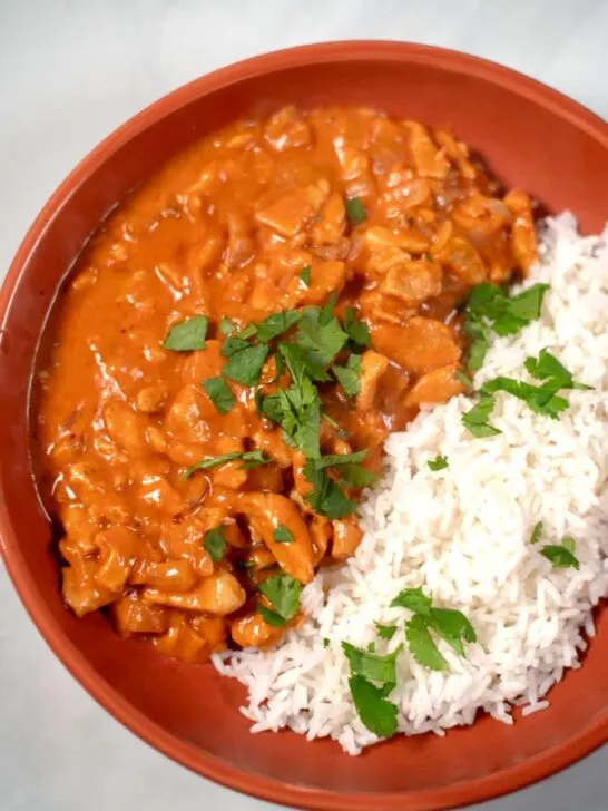 Closeup of a serving of Chicken Masala with rice.