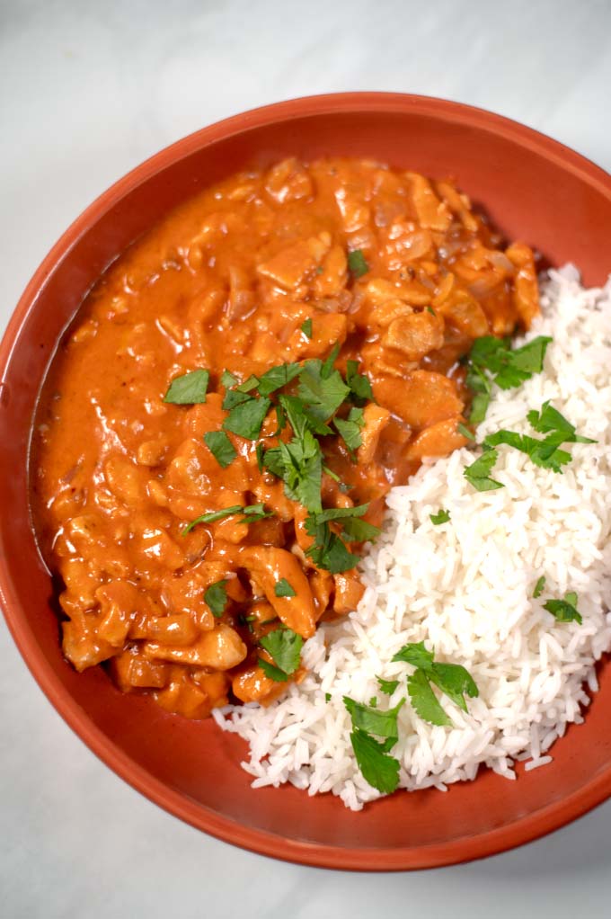 Closeup of a serving of Chicken Masala with rice.