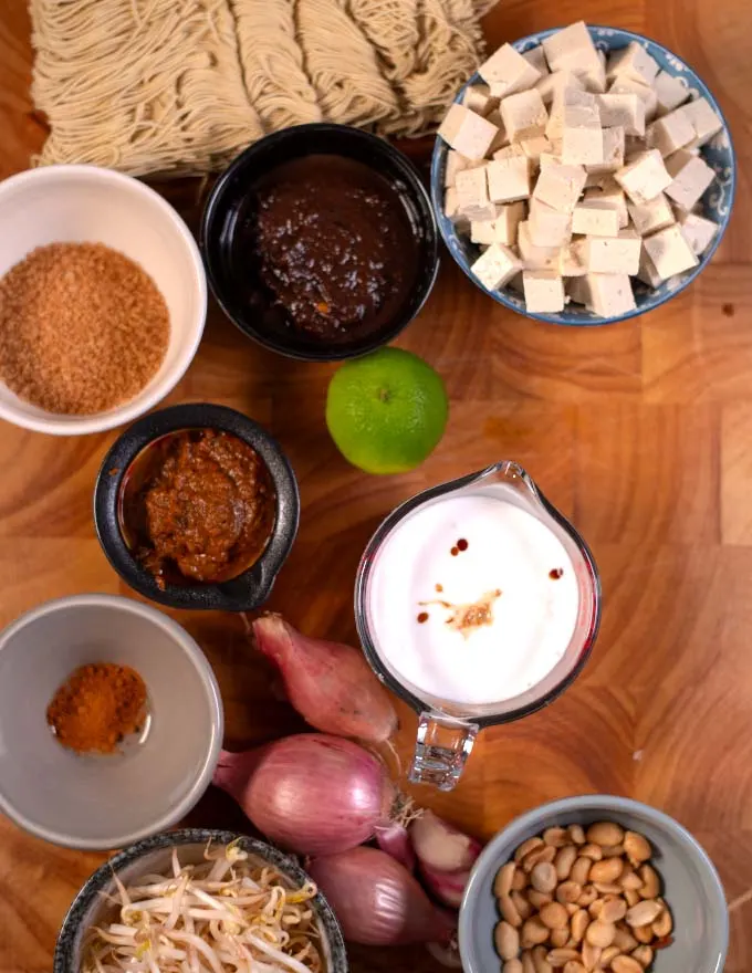 Ingredients needed to make Pad Thai Curry on a wooden board.