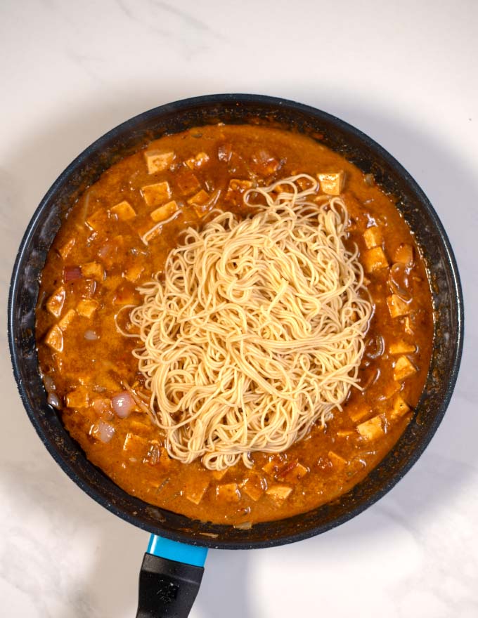 Noodles are added to the sauce.