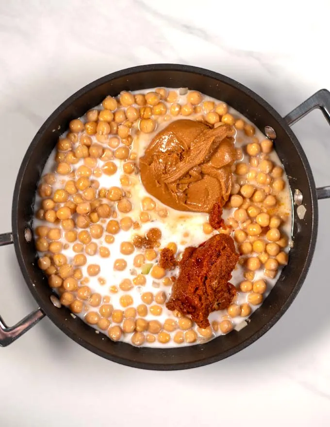 Top view of a pan with the chickpeas and sauce ingredients.