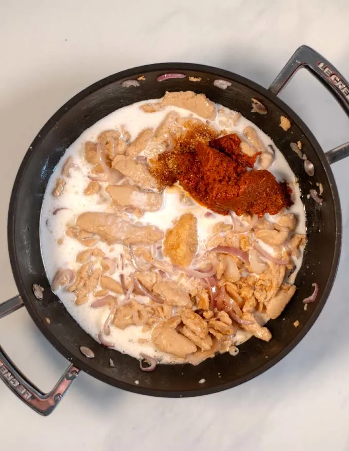 Curry sauce ingredients are added to the pan.