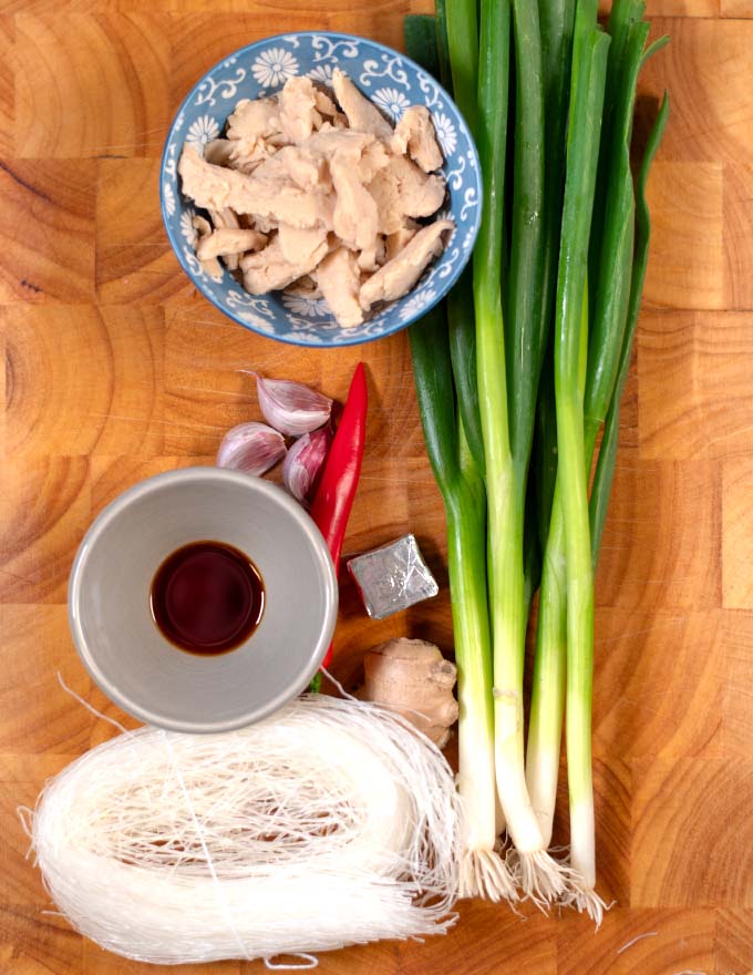 Ingredients needed to make Chicken Long Rice collected on a board.