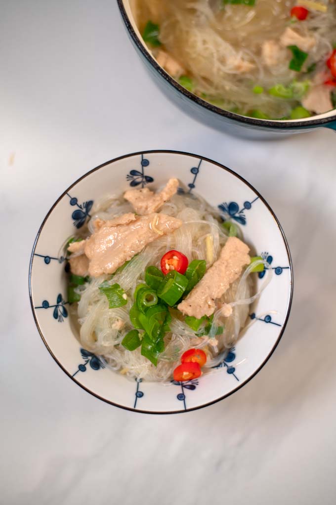 Chicken Long Rice garnished with fresh scallions.