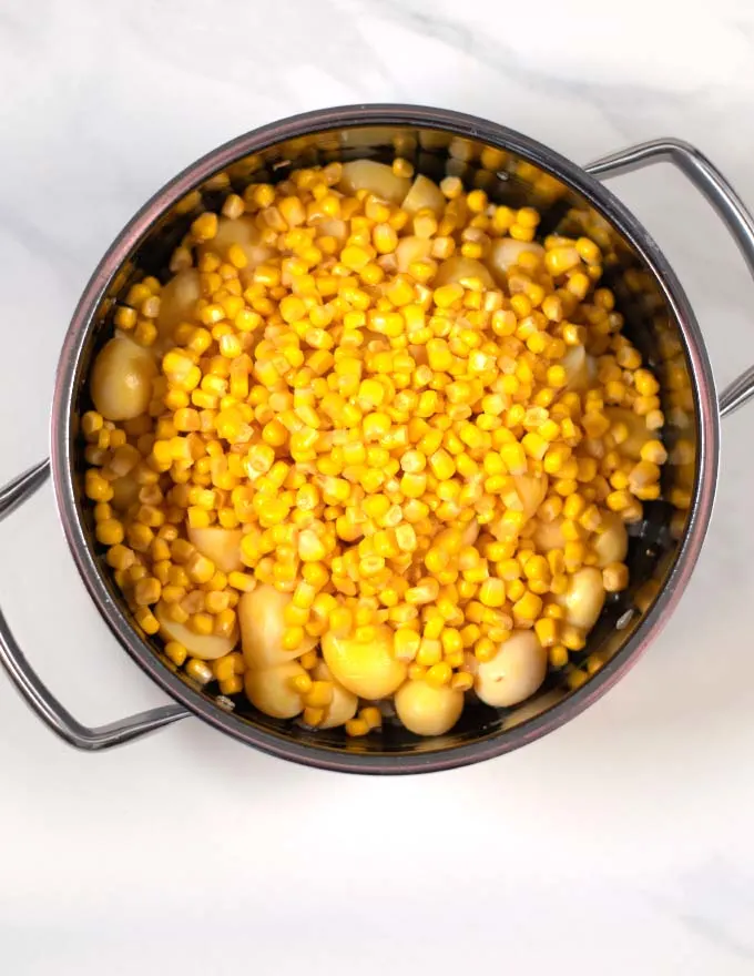 Step-by-step picture showing the addition of potatoes and corn.