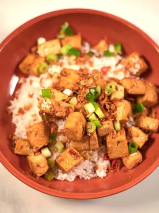 A serving of Chinese Tofu over white rice.