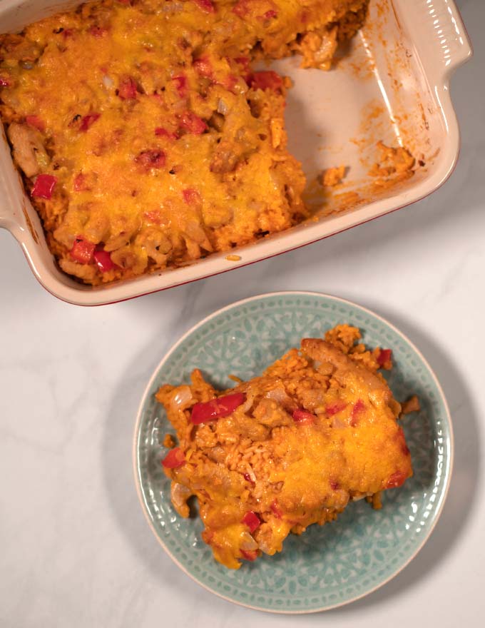 A serving of Arroz Imperial with baking dish in the background.