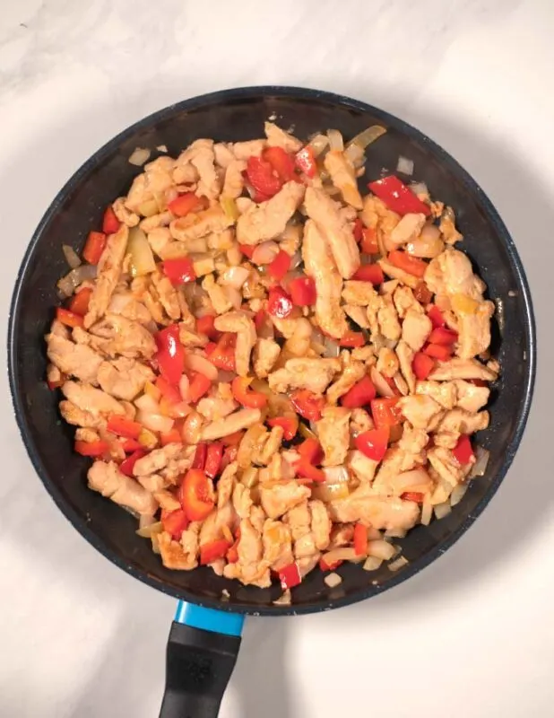 Chicken and vegetable mixture in a pan.