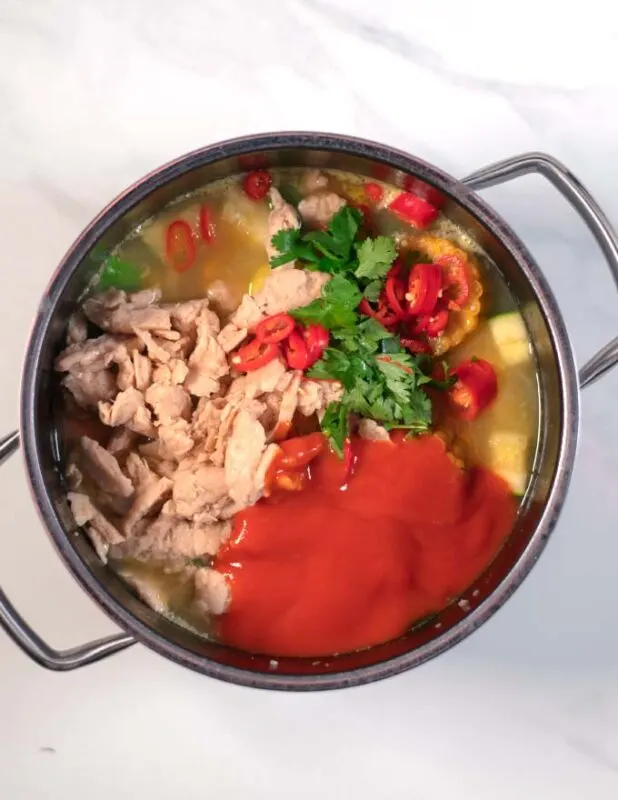 Plant-based chicken, tomato sauce, cilantro, and chili are given to the Caldo de Pollo.