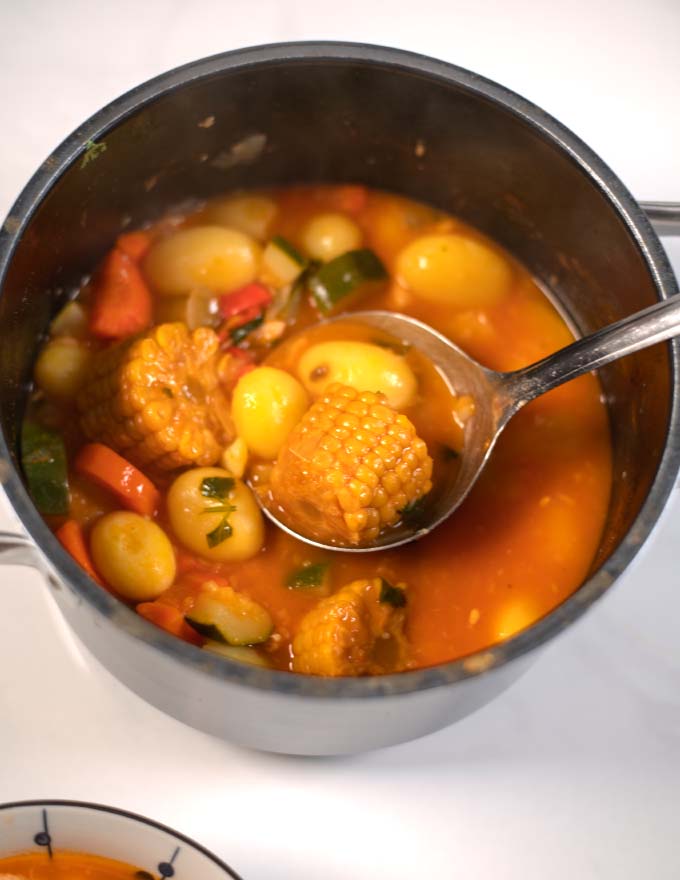 A large serving spoonful of Caldo de Pollo.