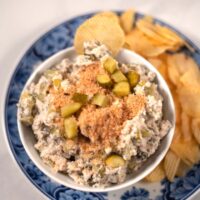 Closeup of a serving of Fried Pickel Dip with potato chips.