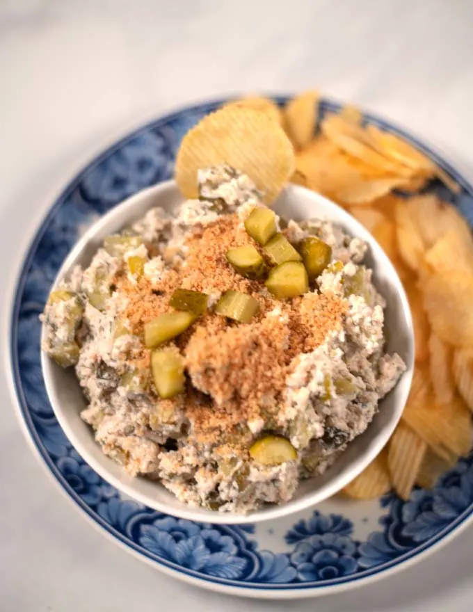 Closeup of a serving of Fried Pickel Dip with potato chips.