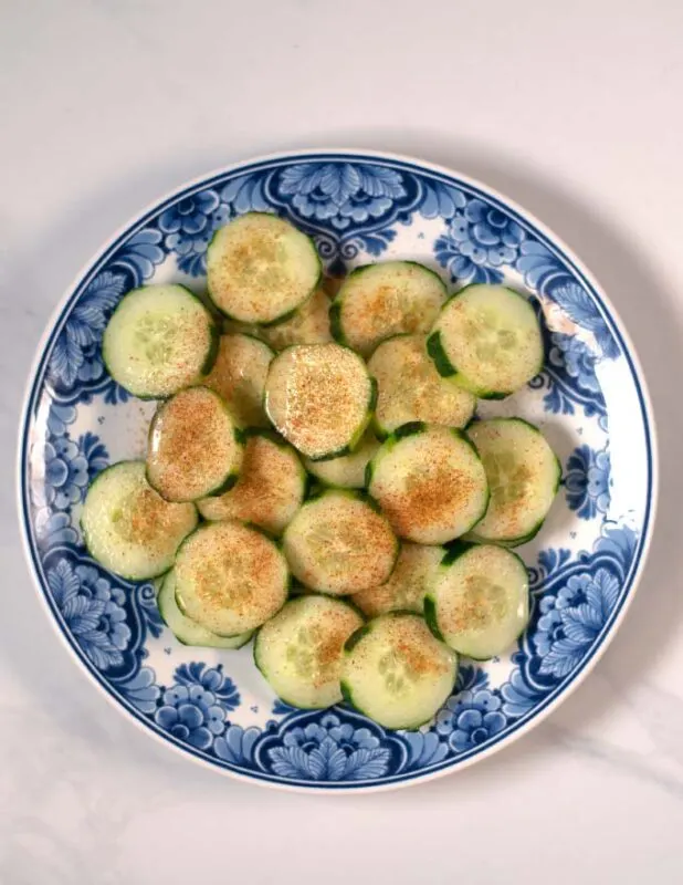 Lime juice and chili powder is given over the cucumber slices.