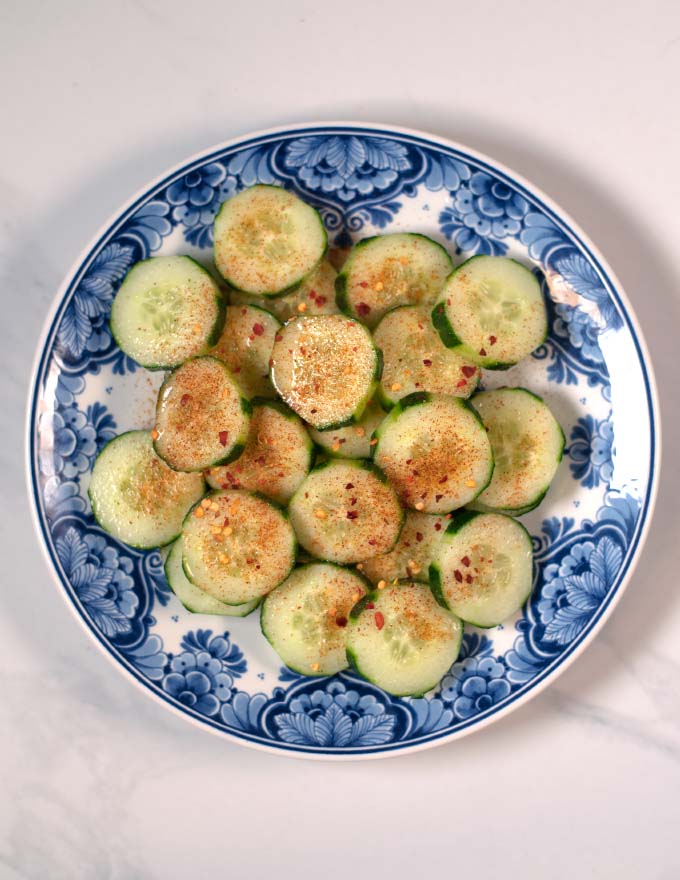 Extra chili flakes are given over Mexican Cucumbers.