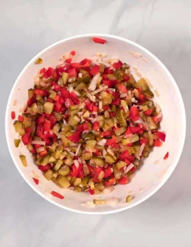 View of a large white mixing bowl with the combined chopped ingredients.