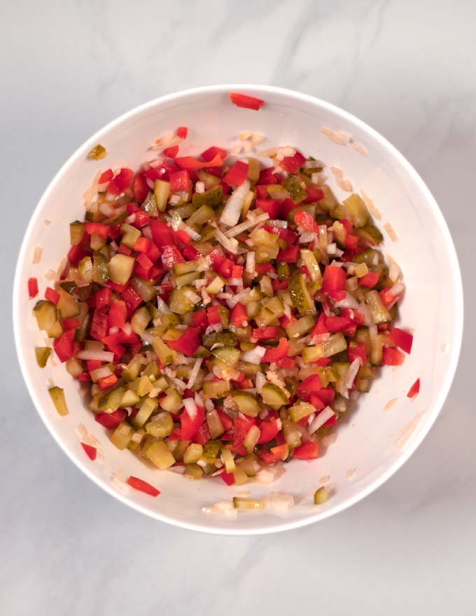 View of a large white mixing bowl with the combined chopped ingredients.