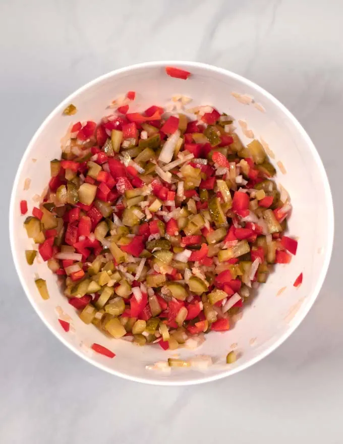 View of a large white mixing bowl with the combined chopped ingredients.