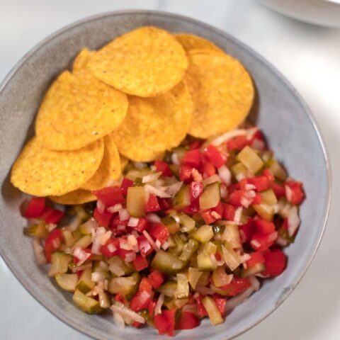 Top view of a serving of Pickle de Gallo with nacho chips.