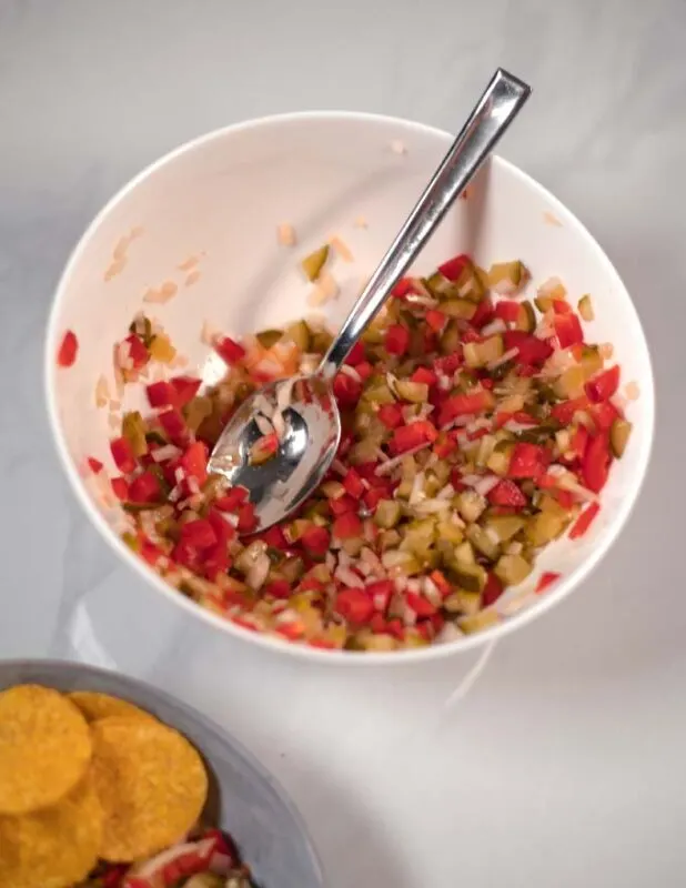 Closeup of a white mixing bowl with a spoon.