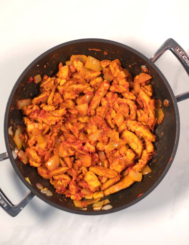 The fried curry chicken in a pan.